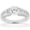 A silver engagement ring features a large round diamond center stone with smaller stones set along the band.