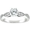A silver engagement ring featuring a central round diamond and smaller accent stones on each side.