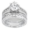 A silver wedding ring featuring a large round diamond and smaller diamonds set along the band.