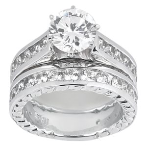 A silver wedding ring featuring a large round diamond and smaller diamonds set along the band.
