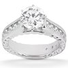 A silver engagement ring features a large round diamond at the center, surrounded by smaller stones along the band.