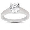 A silver ring features a large, round, clear diamond set in a four-prong setting.