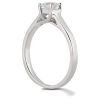 A silver ring with a large clear gemstone set in a four-prong setting.