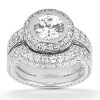 A silver ring set featuring a large circular diamond surrounded by smaller diamonds.