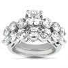 A close-up view of a multi-tiered diamond engagement ring featuring a central round stone surrounded by smaller round stones on a silver band.