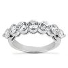 A silver ring with multiple sparkling round diamonds arranged in a curved pattern.