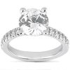 A silver engagement ring featuring a large round diamond center stone and smaller accent stones on the band.