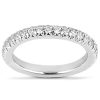 A silver ring adorned with small clear gemstones encircles a smooth band.