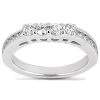 A silver ring features multiple clear gemstones set across the top.