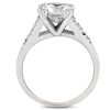 A white gold engagement ring features a large, heart-shaped diamond with smaller accent stones along the band.