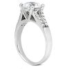 A silver engagement ring features a large central diamond and small accent stones along the band.