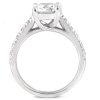 A silver engagement ring with a large central clear gemstone and intricate side detailing is displayed.