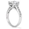 A silver ring with a large clear gemstone and small accent stones along the band is displayed at an angle.