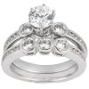 A silver ring set featuring a large central diamond and smaller diamonds in a clustered arrangement on the band.