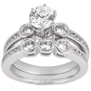 A silver ring set featuring a large central diamond and smaller diamonds in a clustered arrangement on the band.