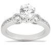 A silver engagement ring featuring a large central diamond flanked by two smaller round diamonds.
