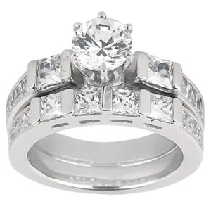 A silver engagement ring with a central round diamond and multiple square-cut diamonds surrounding it.