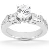A silver ring featuring a large central round diamond flanked by two smaller square-cut diamonds.
