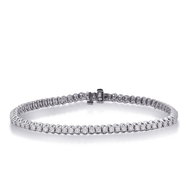 A silver bracelet with a row of clear gemstones is displayed in a horizontal position on a flat surface.
