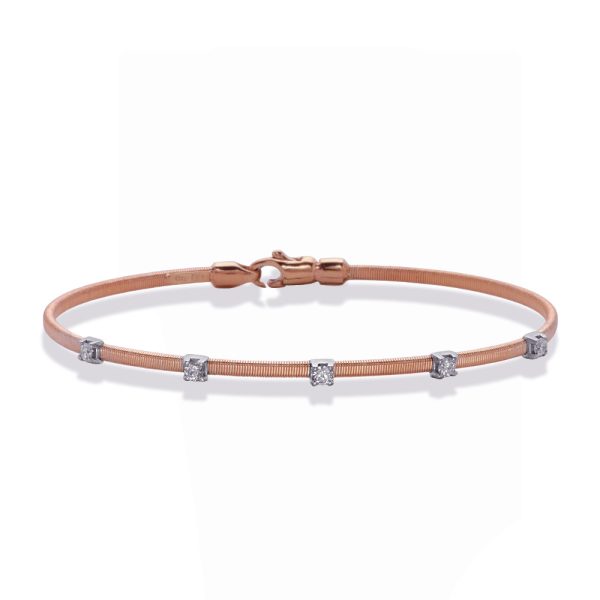 A rose gold bracelet with silver accents and small gemstones is displayed against a white background.