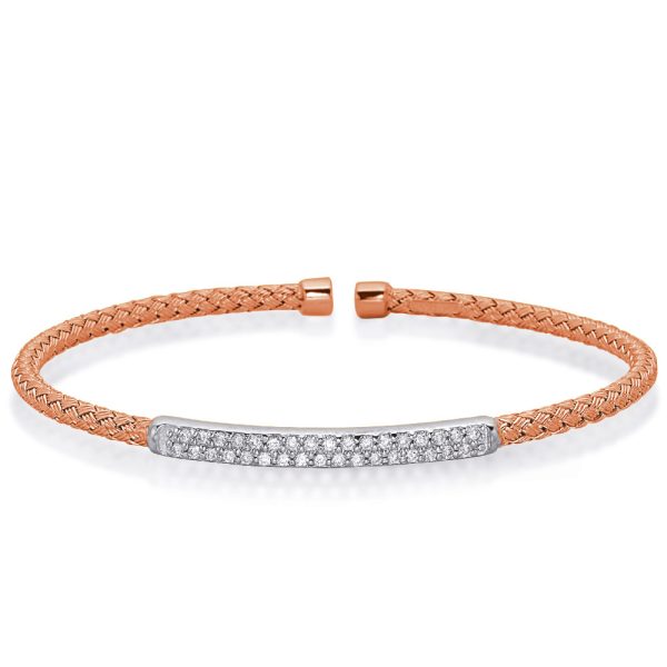 A rose gold braided bracelet with a silver bar featuring embedded gemstones is displayed against a white background.