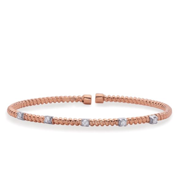 A rose gold bracelet with twisted detailing and five small, clear gemstones.