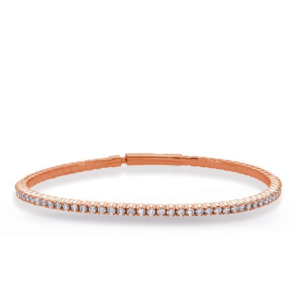 A rose gold bangle bracelet adorned with small sparkling stones is displayed against a white background.