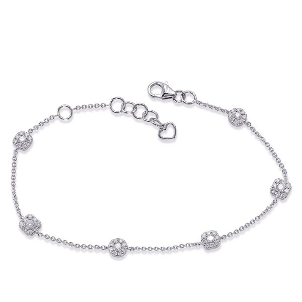A silver bracelet with several decorative elements and a lobster clasp.