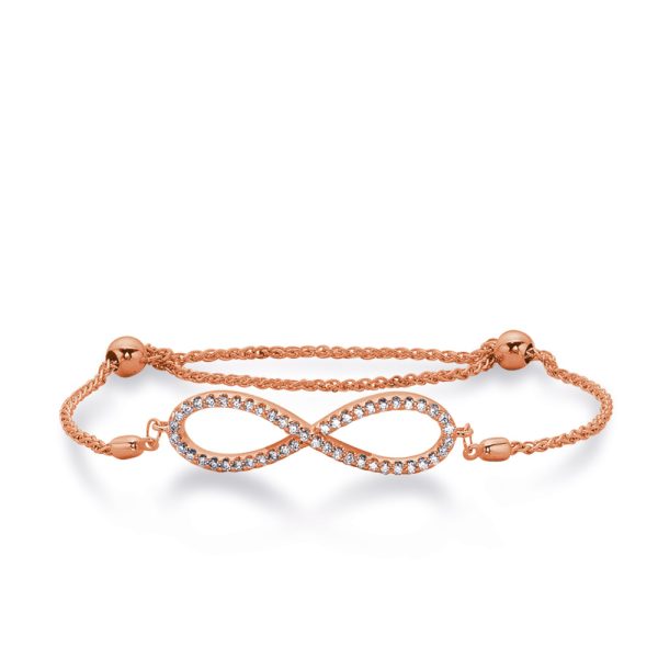 A rose gold bracelet features an infinity symbol adorned with sparkling gemstones.