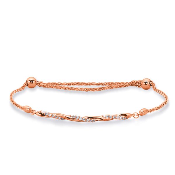 A rose gold bracelet with a twisted design and sparkling embellishments is displayed on a white background.