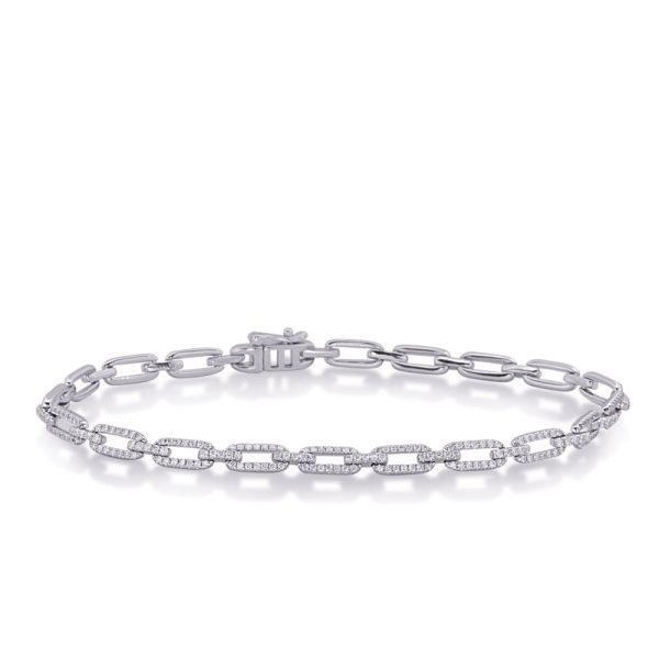 Silver chain bracelet with links and small embedded stones displayed on a flat surface.