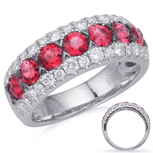 A silver band ring features alternating red gemstones and clear diamonds in a decorative arrangement.