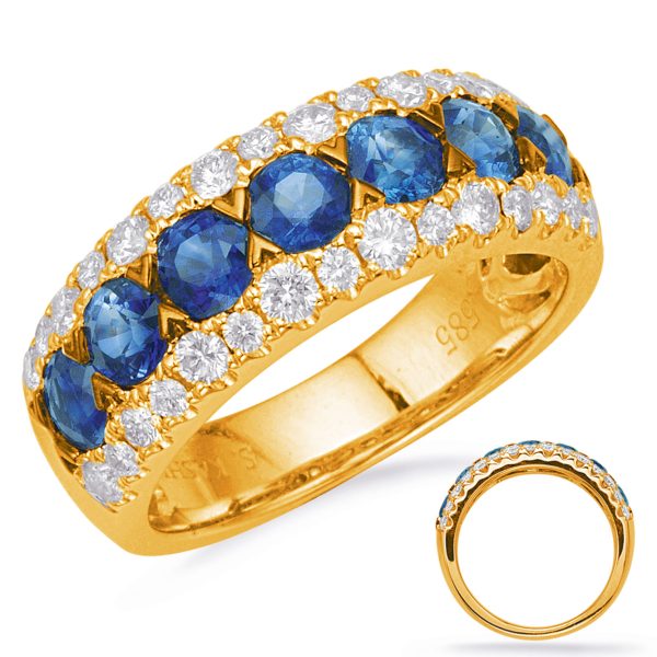 Gold ring featuring blue gemstones and diamonds arranged in a decorative pattern.