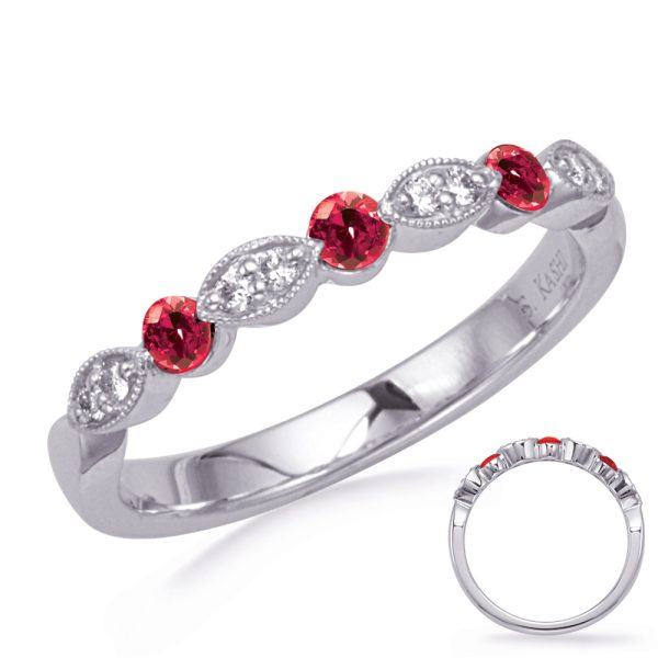 A silver ring features alternating red and clear gemstones set in a delicate pattern.
