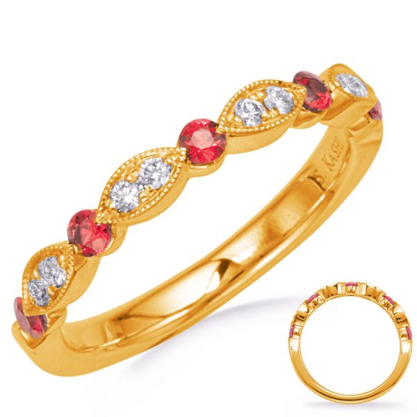 A gold ring featuring a pattern of alternating red and clear gemstones is displayed prominently.