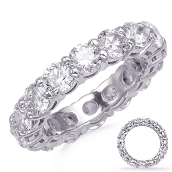 A diamond-studded ring with a circular design is displayed alongside a smaller circular version of the same ring.