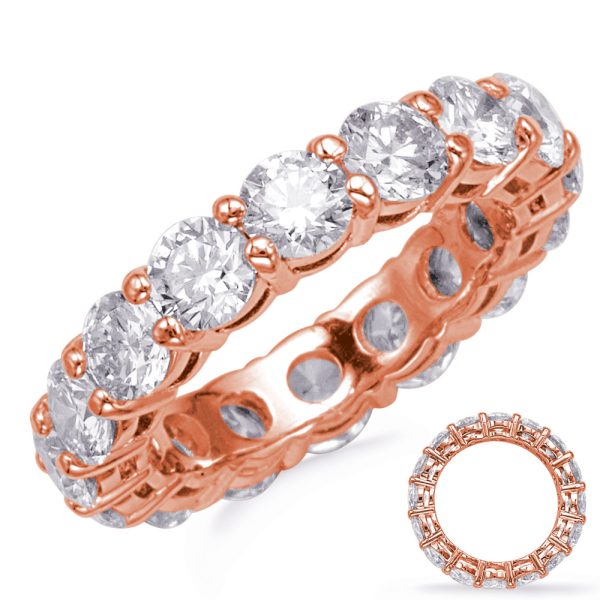 A rose gold eternity ring is adorned with several round, clear gemstones arranged in a continuous band.