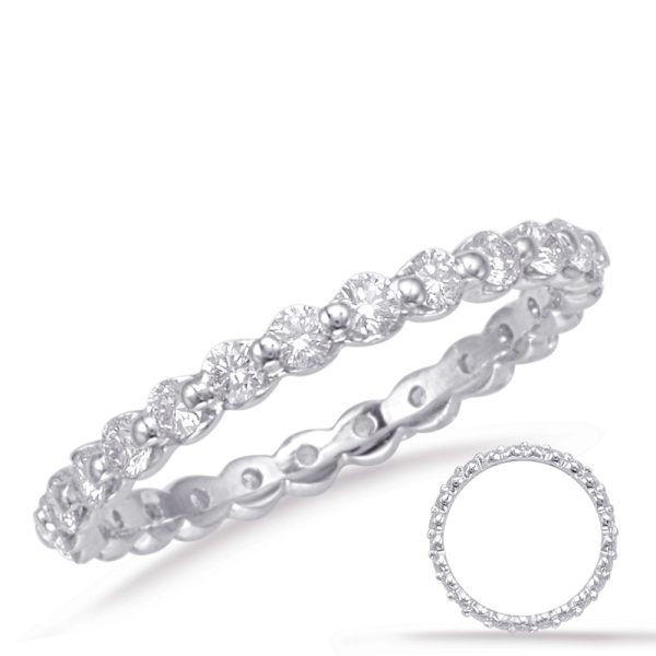 A silver ring featuring a series of round diamonds is displayed prominently with a smaller circular inset showing the ring's design.
