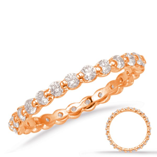 A rose gold ring featuring a row of round diamonds is displayed prominently.