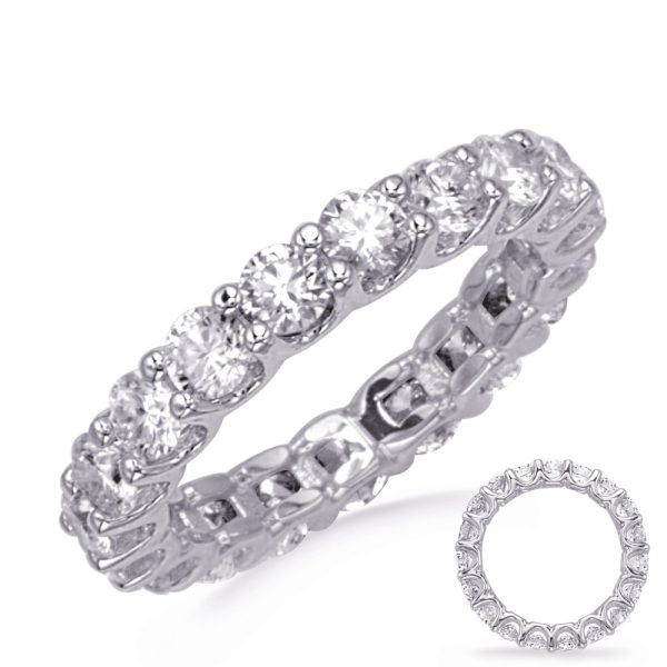 A silver wedding band set with multiple round-cut gemstones is displayed from an angled perspective, highlighting its intricate design.