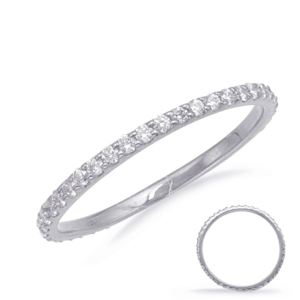 A slim, silver ring adorned with small, shiny gemstones is displayed at an angle, with a second, less detailed ring shown in the lower right corner.