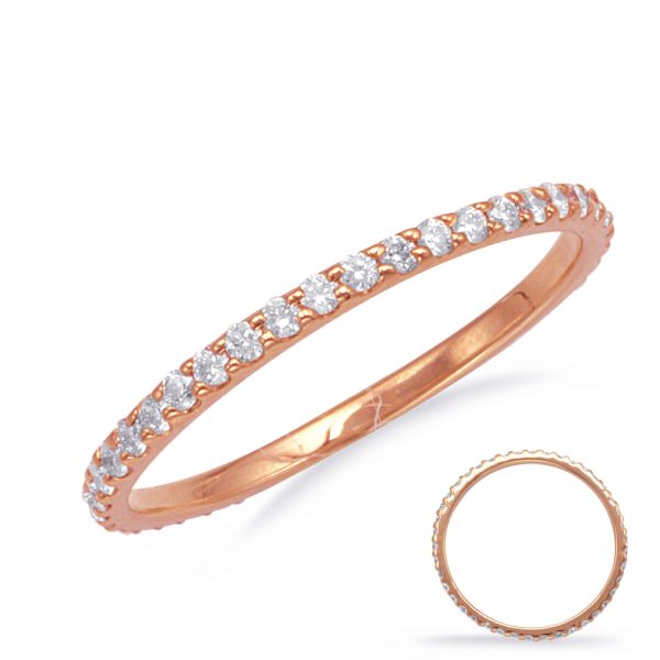 A rose gold ring with a row of small, clear gemstones set into its surface is displayed prominently.