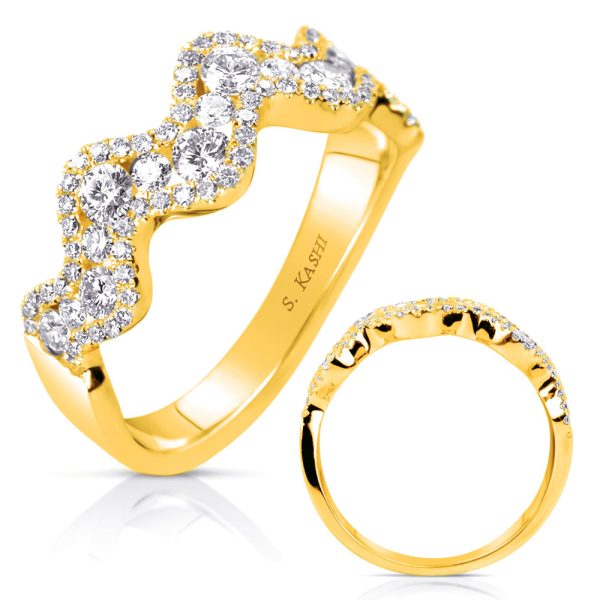 A gold ring with a wavy design and sparkling diamonds is positioned next to a simpler gold band.