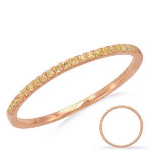 A rose gold ring adorned with small yellow stones is displayed on a white background.