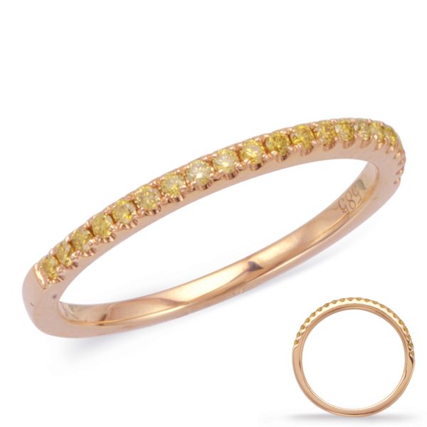 A rose gold ring features a row of yellow stones along its band.