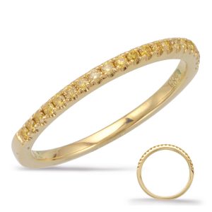 A yellow gold ring with a row of small, clear gemstones is displayed against a white background.