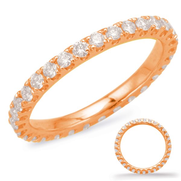 A rose gold ring is shown adorned with multiple clear gemstones along its band.