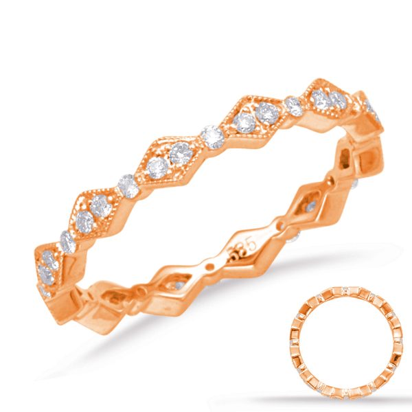A rose gold ring with a zigzag design featuring multiple sparkling stones is displayed against a white background.