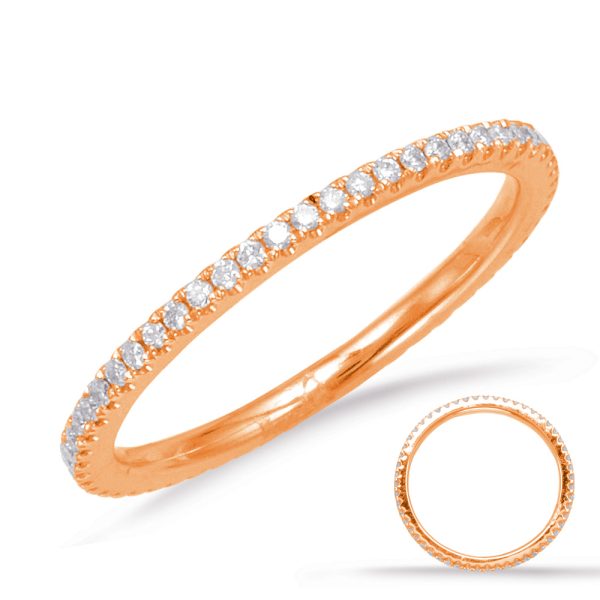 Rose gold ring with a row of clear gemstones embedded along the band.