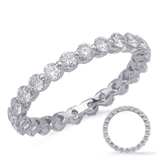 A silver ring set with a continuous line of clear gemstones is displayed alongside a second, similar ring.